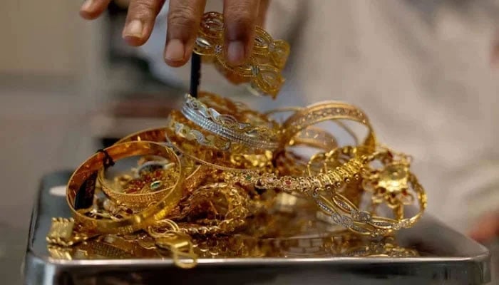 A goldsmith weighs gold jewellery inside a showroom in Ahmedabad, India, July 31, 2025. — Reuters