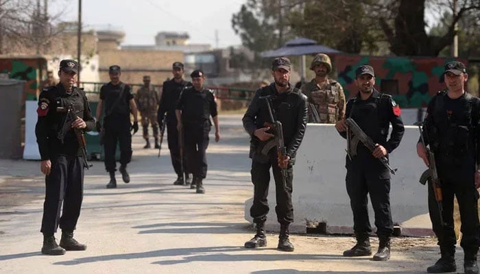 KP police personnel stand guard in KP. — AFP/File