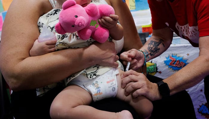 A one-year-old receives a dose of Moderna Spikevax (COVID-19 Vaccine, mRNA) at Skippack Pharmacy in Schwenksville, Pennsylvania, US October 2, 2025.—Reuters
