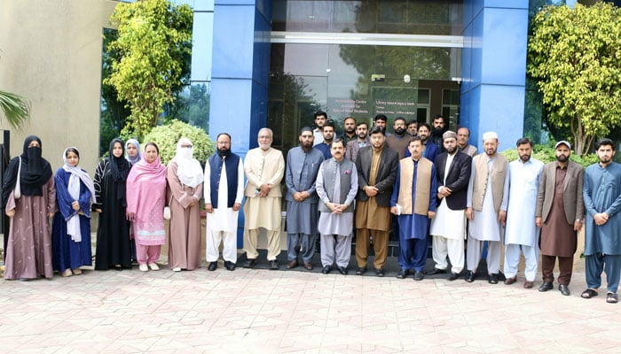 The image shows a group photo of the participants an important intellectual session on Seerat-un-Nabi (Peace Be Upon Him) organised by the Allama Iqbal Open University (AIOU) on March 17, 2026. — Facebook@AIOU.OfficialAccount