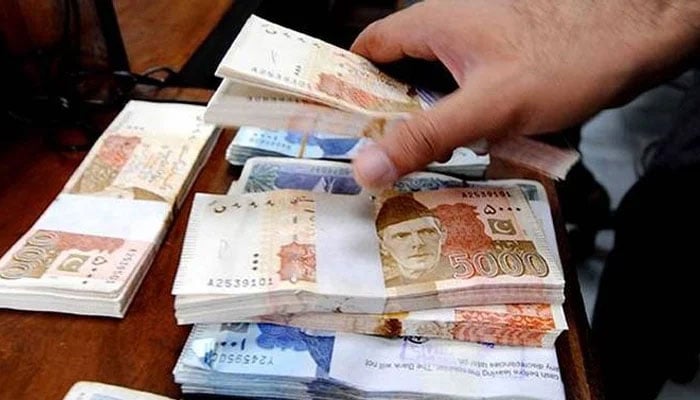 Stacks of Rs5,000 and Rs1,000 notes. — AFP/File