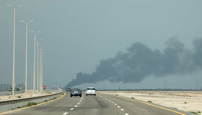 Vehicles move along a road as smoke billows from Saudi Aramcos Ras Tanura oil refinery after a reported Iranian drone strike, amid the US-Israel conflict with Iran, in Ras Tanura, Saudi Arabia, March 2, 2026.—Reuters