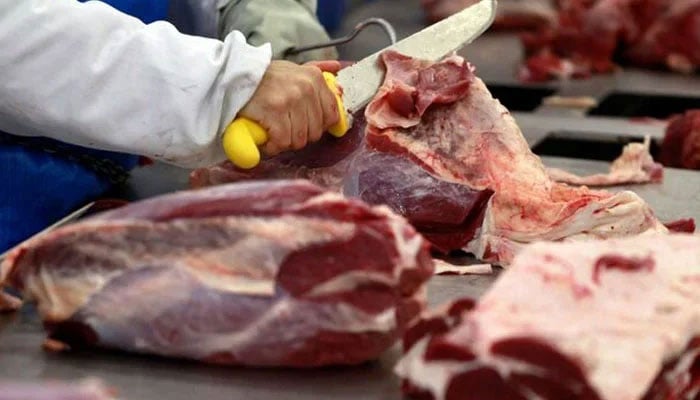 A worker cutting up joints of beef at an unspecified slaughterhouse.— Reuters/File