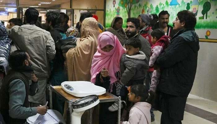 A representational image showing parents pictured alongside their children at the Children’s Hospital in Lahore. — AFP/File