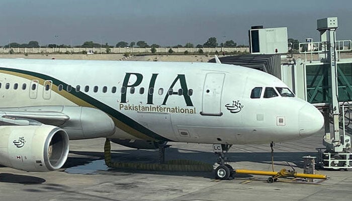 View of the Pakistan International Airlines (PIA) passenger plane, taken through a glass panel, at Islamabad International Airport, Pakistan, October 3, 2023. — Reuters