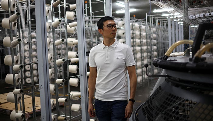 The representational image shows David Kim, chief executive of the family-run Amesud textile plant, walks among rows of spools of yarn next to company machinery, in San Martin, on the outskirts of Buenos Aires, Argentina, March 4, 2026. — Reuters