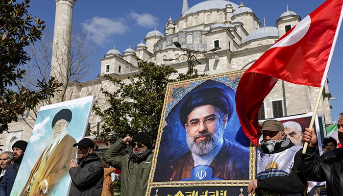 Demonstrators hold posters of Irans late Supreme Leader Ayatollah Ali Khamenei and his son, Irans new Supreme Leader Mojtaba Khamenei, during a rally to mark al-Quds Day (Jerusalem Day), amid the US-Israeli conflict with Iran, after Friday prayers at Fatih Mosque in Istanbul, Turkey, March 13, 2026. — Reuters