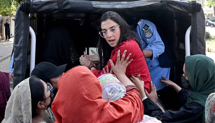 Police personnel dressed in plain clothes detain activists of the womens rights group Aurat March, upon their arrival ahead of a rally on International Womens Day in Islamabad on March 8, 2026. — AFP