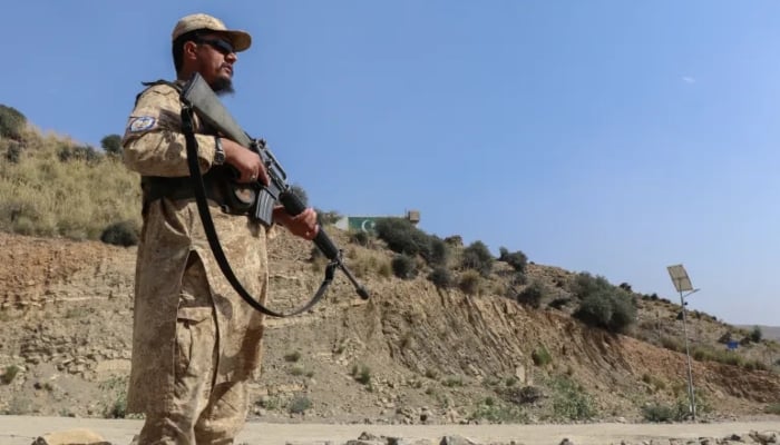 Taliban security personnel stand guard along a road near the Ghulam Khan zero-point border crossing between Afghanistan and Pakistan in Gurbuz district in the southeast of Khost province on October 20, 2025. —AFP