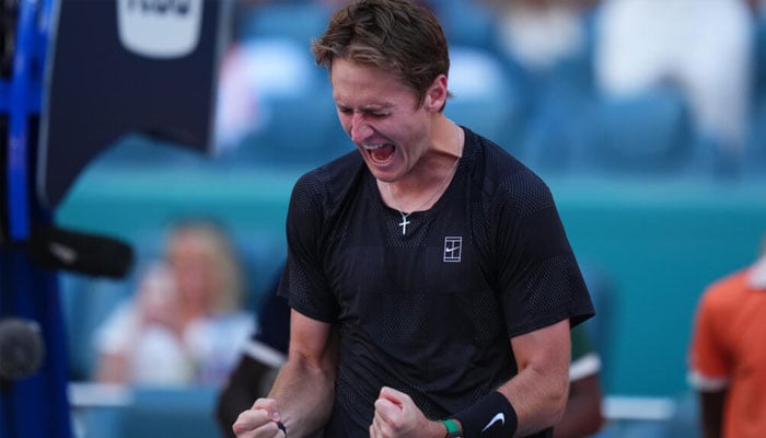 American Sebastian Korda celebrates his upset triumh over world number one Carlos Alcaraz in the third round of the Miami Open. —AFP
