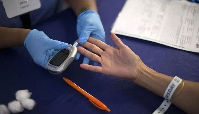 A representational image shows a diabetic patient conducting a diabetes test. — Reuters/File