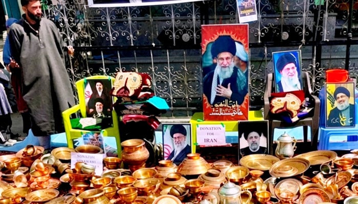 A Kashmiri man standing beside the donated precious metals by residents in Indian-held Kashmir, March 23, 2026. —Facebook@greatkashmir123