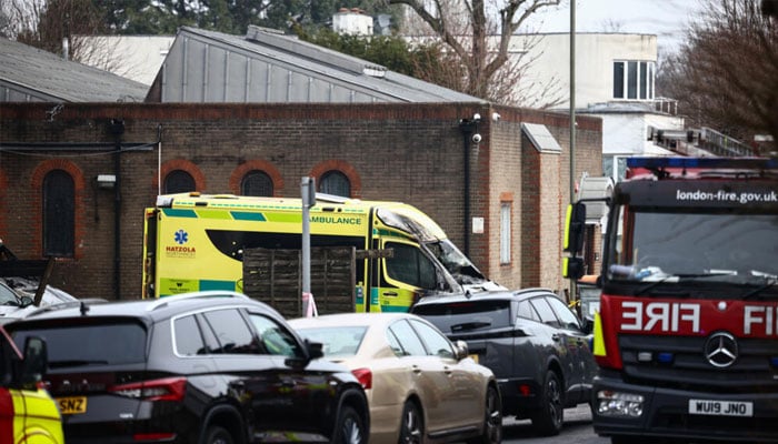 A damaged and burnt-out ambulance is pictured along a street in Golders Green, north London. — AFP