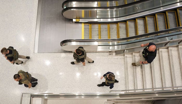 Immigration and Customs Enforcement agents walk at Newark Liberty International Airport, as hundreds of them were ordered to deploy to airports to help fill TSA staffing gaps, in Newark, New Jersey, US, March 23, 2026.—Reuters
