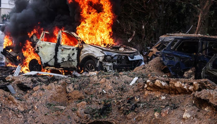 Fire engulfs a car at a site following Iranian missile barrages in central Israel, amid the U.S.-Israel conflict with Iran, in Tel Aviv, Israel, March 24, 2026.—Reuters