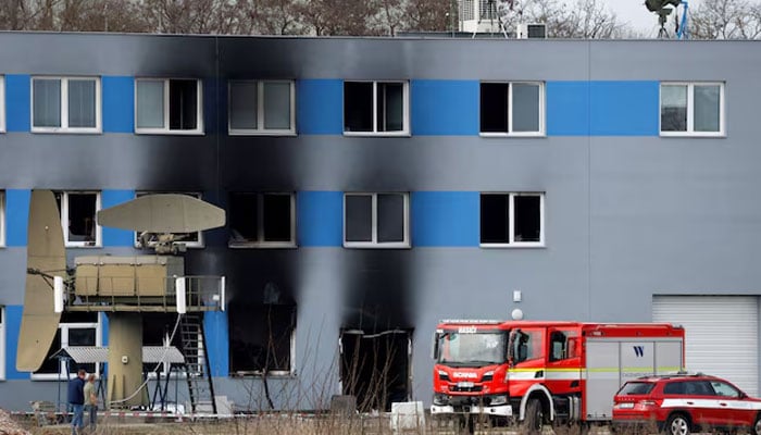 A firetruck stands in front of a burned production hall at an industrial area in Pardubice, Czech Republic, March 20, 2026.—Reuters