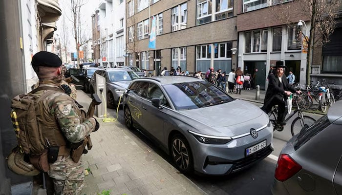 A Jewish man rides past Belgian army personnel patrolling a street as part of a deployment of soldiers outside Jewish institutions in Antwerp and Brussels following attacks at Jewish sites in Belgium and other European countries, in Antwerp, Belgium, March 23, 2026.—Reuters