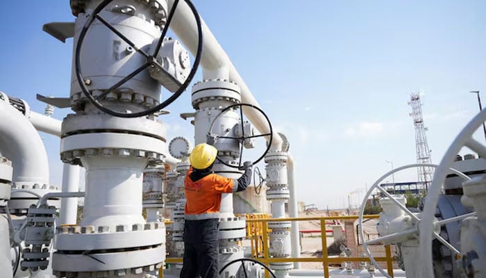 A worker operates valves at the Rumaila oil field, as the country cuts nearly 1.5 million barrels per day of output amid halted exports following the closure of the Strait of Hormuz, in Basra, Iraq, March 4, 2026.—Reuters
