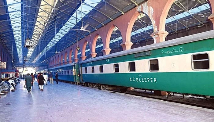 Passengers walk by at a railway station in this undated photo. — Radio Pakistan/File