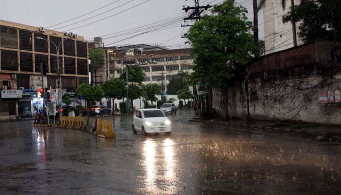 Commuters are passing through a road during the downpour of summer season, at Shimla Hill in Lahore on May 11, 2025. — PPI