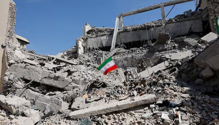 An Iranian flag stands in the rubble following a strike on a police station in Tehran, Iran, March 4, 2026. —Reuters