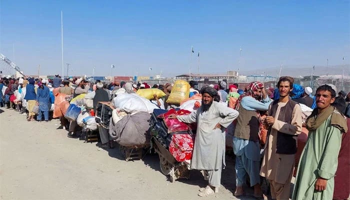 Afghan citizens wait with their belongings to cross into Afghanistan in Chaman on October 31, 2023. — Reuters