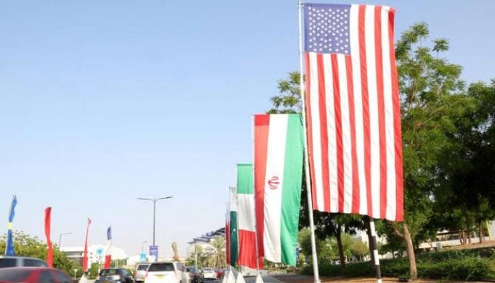 The flags of the US and Iran on the road leading to the Muscat International Book fair, Oman, April 25, 2025. — AFP