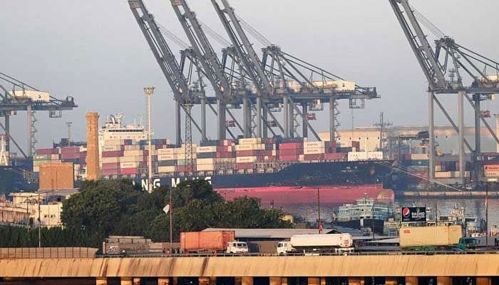 Shipping containers are seen stacked on a ship at a sea port in Karachi. — AFP/File