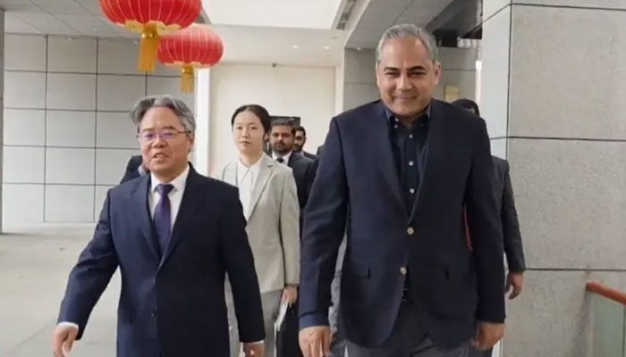 Interior Minister Mohsin Naqvi walks with Chinese Ambassador Jiang Zedong at the Chinese Embassy in Islamabad on March 27, 2026. — X@ForeignOfficePk