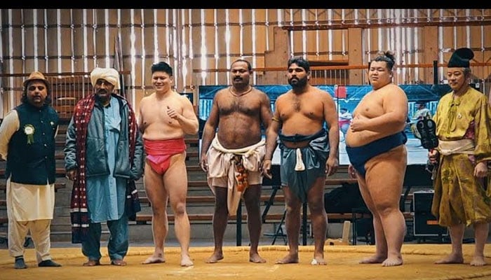 Pakistans Pahlwans and Japan’s sumo wrestlers posing during International Pakistan Osaka Cultural Festival. —Screengrab via Youtube