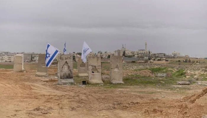 A photograph shows Israeli flags and a Gush Etzion council flag at the newly built Israeli settler outpost of “Yatziv” on the outskirts of the Palestinian town of Beit Sahur in the Israeli-occupied West Bank. — AFP/File