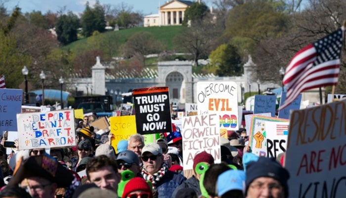 Demonstrators walk from Virginia into the US capital, Washington during a ‘No Kings’ national day of protest against US President Donald Trump and his policies. —AFP