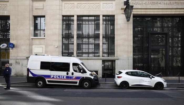 A policeman stands outside the Bank of America building in Paris on March 28, 2026. — AFP