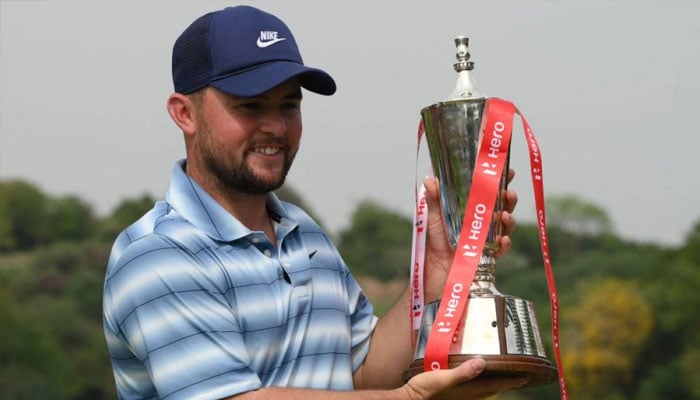 England’s Alex Fitzpatrick poses with the trophy after winning the Indian Open golf tournament of the DP World Tour in Gurgaon on March 29, 2026.— AFP