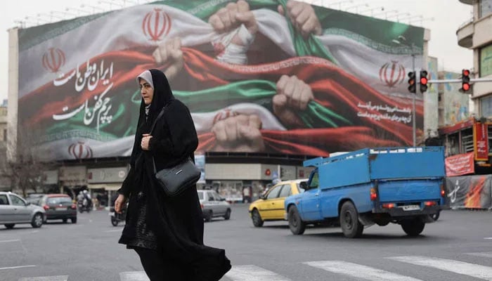An Iranian woman walks on a street in Tehran, Iran, January 19, 2026. — Reuters