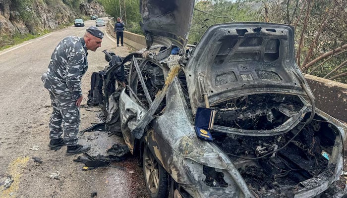A police officer looks at the destroyed car of Lebanese journalists Al Mayadeen reporter Fatima Ftouni and cameraman Mohammed Ftouni, and Al Manar reporter Ali Shaib, killed by a targeted Israeli strike, amid escalating hostilities between Israel and Hezbollah, as the US-Israeli conflict with Iran continues, in Jezzine, in southern Lebanon, March 28, 2026. — Reuters