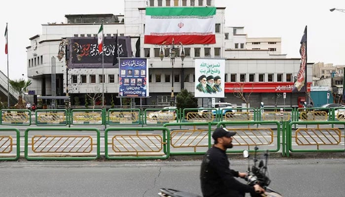A banner with a picture of the late leader of the Islamic Revolution, Ayatollah Ruhollah Khomeini, and the late Supreme Leader of Iran, Ayatollah Ali Khamenei and Irans new Supreme Leader, Mojtaba Khamenei, is displayed on a street, amid the US-Israeli conflict with Iran, in Tehran, Iran, March 23, 2026.—Reuters
