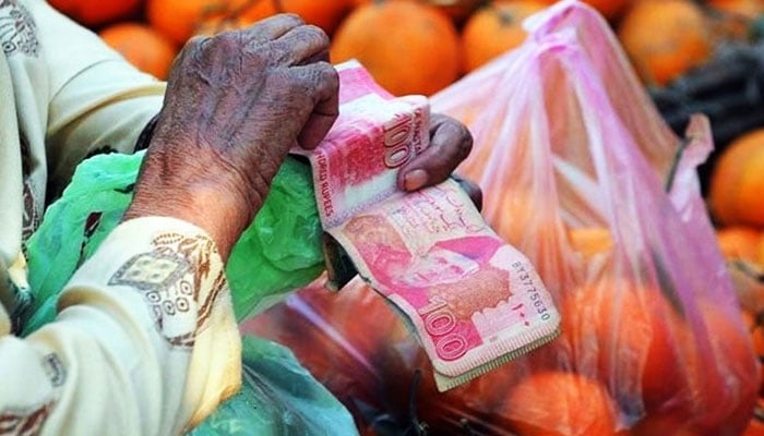The representational image shows a person counting currency notes. — AFP/File
