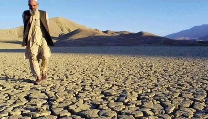 A man walks on the dried, cracked landscape near Hanna Lake near Quetta, Pakistan. — AFP/File