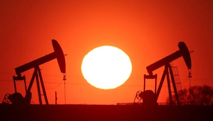 The sun sets behind oil pumps outside Vaudoy-en-Brie, near Paris, France, March 18, 2026. — Reuters