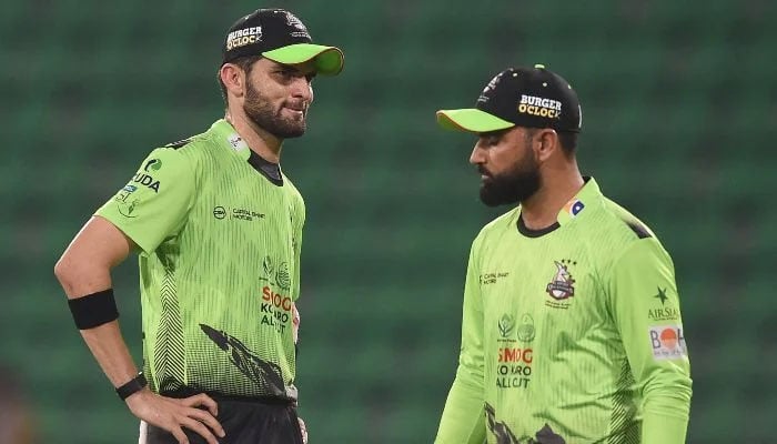 Lahore Qalandars captain Shaheen Shah Afridi (L) speaks with teammate Fakhar Zaman (R) during the Pakistan Super League (PSL) T20 match between Karachi Kings and Lahore Qalandars at the Gaddafi Cricket Stadium in Lahore on March 29, 2026. — AFP