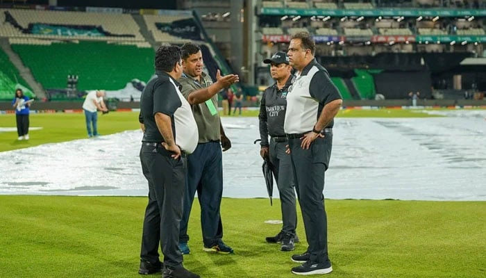 Match officials inspect the outfield under lights at the Gaddafi Stadium in Lahore after rain delayed the PSL 11 match between Peshawar Zalmi and Islamabad United on March 31, 2026. — PCB