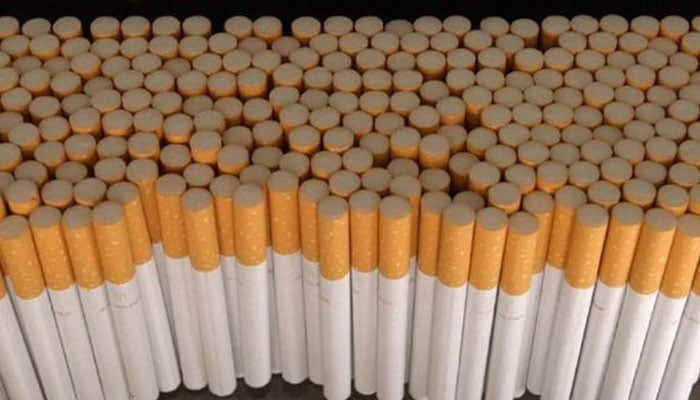 The representational image displays a large quantity of manufactured cigarettes, which are tobacco products designed for smoking. — The News/File