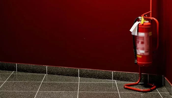 This representational image shows a fire extinguisher in the corner of a building. — Unsplash/File