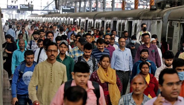 Commuters walk on a platform after disembarking from a suburban train at a railway station in Mumbai, India, January 21, 2023. —Reuters