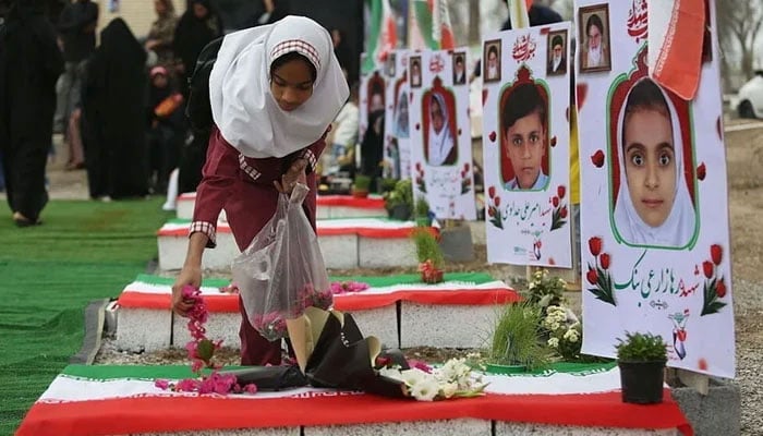This image captures a moment of deep mourning during Nowruz, the Persian New Year, on March 20, 2026, at a cemetery in Minab, Iran. — Iranian state media /File