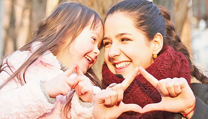 A representational image of an autistic child posing with her mother for photo. —TheNews/File
