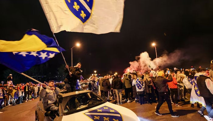 Bosnian supporters celebrate after Bosnia and Herzegovina beat Italy on penalties in a FIFA World Cup 2026 European playoff final, in Zenica, Bosnia and Herzegovina, April 1, 2026.—Reuters
