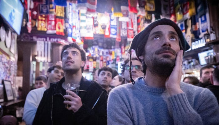 Italy supporters watch the loss to Bosnia in a pub in central Rome. —AFP/File