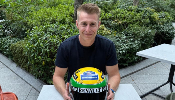 Canadian collector Darren Jack shows off the iconic yellow helmet which belonged to Formula One legend Ayrton Senna. —AFP